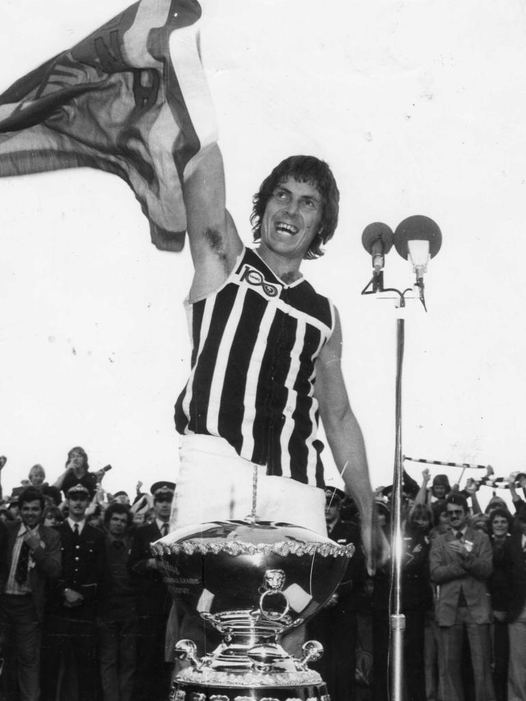 Russell Ebert proudly holds the premiership flag after Port Adelaide’s 1977 grand final win.