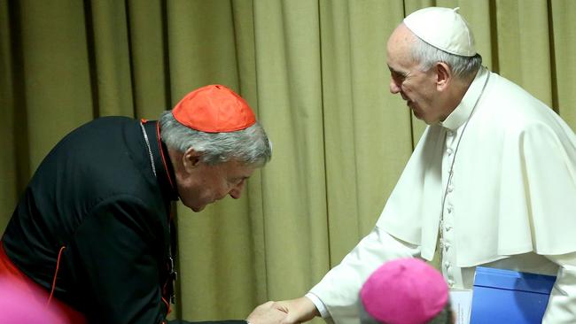 Pope Francis greets Australian Cardinal George Pell as he arrives at the Synod Hall in Vatican City in 2015, for a session of Synod. Picture: Getty Images