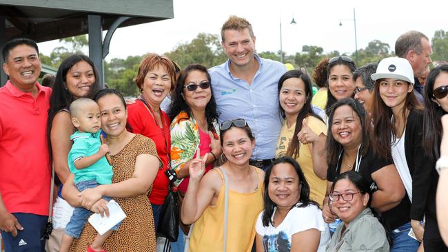 Thomas Foods chief executive Darren Thomas poses with workers at community BBQ after the fire. Picture: AAP/Russell Millard