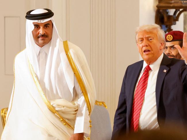 Qatar's Emir Sheikh Tamim bin Hamad al-Thani (L) and US President Donald Trump leave after a signing ceremony at the Royal Palace in Doha on May 14, 2025. (Photo by Karim JAAFAR / AFP)