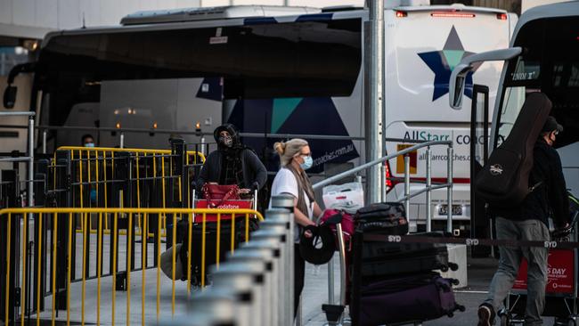 Passengers at Sydney International Airport before being transferred to hotel quarantine in Sydney. Picture: NCA NewsWire / Flavio Brancaleone