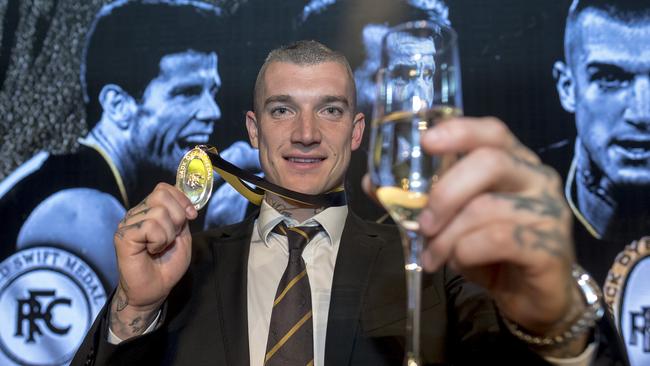 Richmond player Dustin Martin raises his glass after winning the Jack Dyer Medal 2017 award. Picture: AAP Image/Luis Ascui