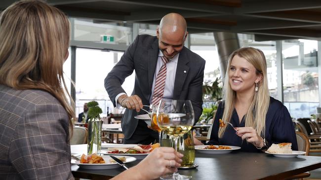 Alessandro Truzzi from a'Mare at Crown Sydney serving Kieran Debney (left) and Brittany Smith. Picture: Jonathan Ng