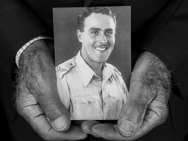 Bob Semple holds a picture of himself aged 21 taken in 1941, when he was 21. Picture: Ian Currie