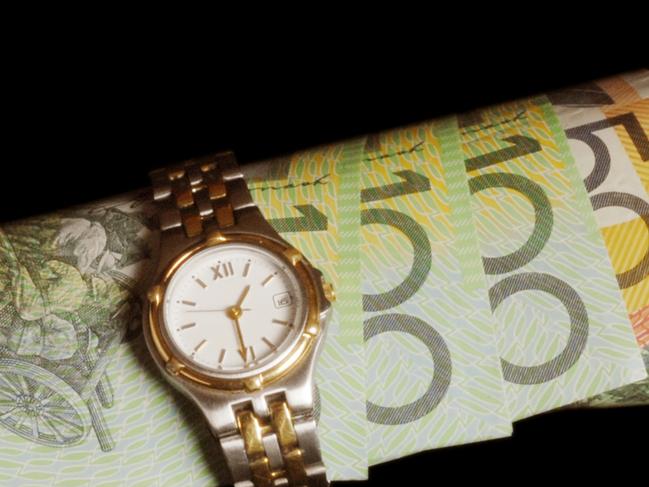 Australian currency wrapped in a watch;  money notes time ticking away generic