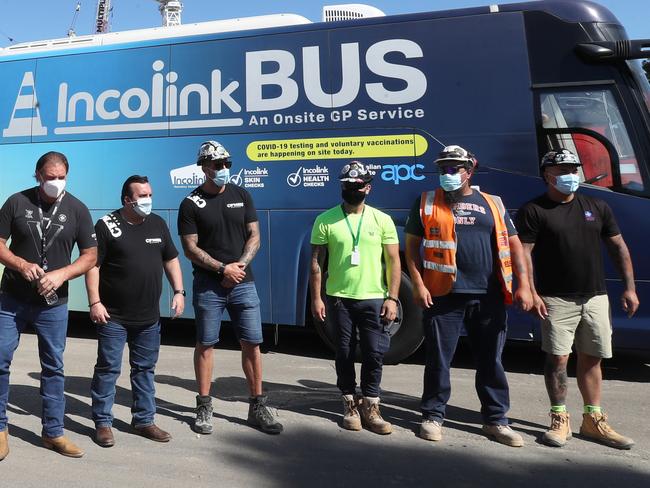 Construction workers receive their booster COVID jabs at a mobile bus clinic in Footscray.  Victorian State Secretary of CFMEU, John Setka  3rd from L)is seen on site with other union bosses.  Wednesday, January 19, 2022. Picture: David Crosling