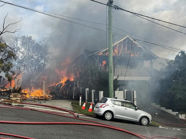 Fire crews are battling multiple house fires in Evelyn Street in Grange. Photo: QFES.