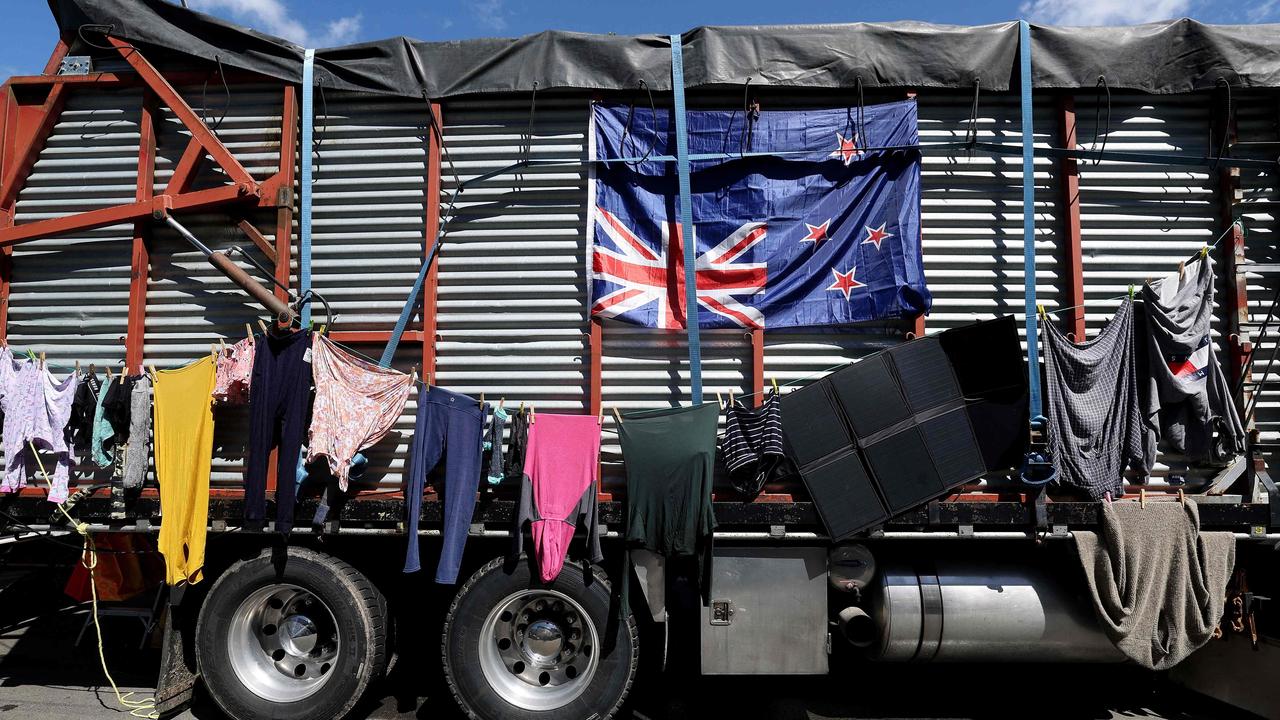 Laundry is hung to dry on the side of a farm truck adorned with a New Zealand flag hung upside-down by demonstrators in Wellington. Picture: AFP