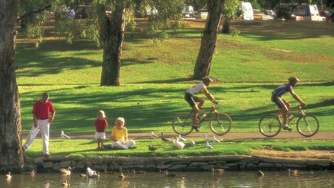 People enjoying Linear Park along the River Torrens.