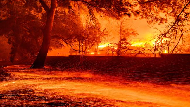 Embers whip across the ground as homes burn during the Eaton fire in Pasadena, California on January 7, 2025. Picture: Josh Edelson / AFP.