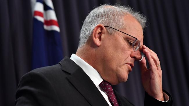 Prime Minister Scott Morrison shows the strain during his news conference at Parliament House on Tuesday. Picture: Getty Images