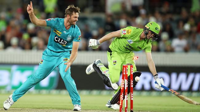 Brisbane Heat’s Mark Steketee runs out Brendan Doggett of Sydney Thunder at Manuka Oval. Picture: Getty Images