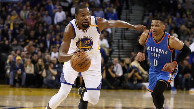 Kevin Durant dribbles past Russell Westbrook.