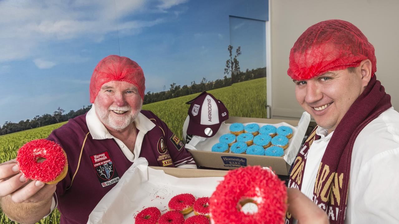 GAME DAY: Wearing their team’s colours with pride are Homestyle Bake Toowoomba director Lindsay Weber (left) and production supervisor Chris Rogers with the special State of Origin doughnuts. Picture: Kevin Farmer