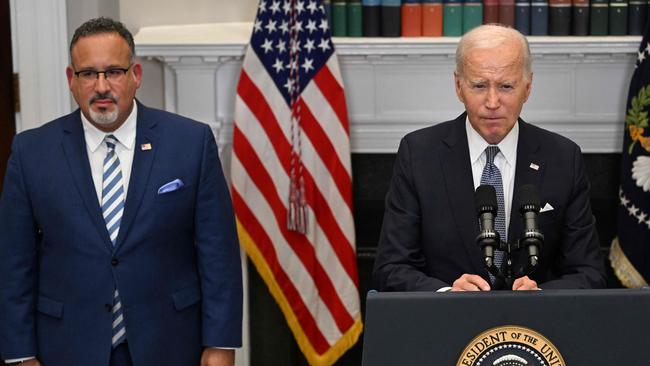 Joe Biden speaks about the US Supreme Court's decision overruling student debt forgiveness as Education Secretary Miguel Cardona looks on. Picture: AFP.