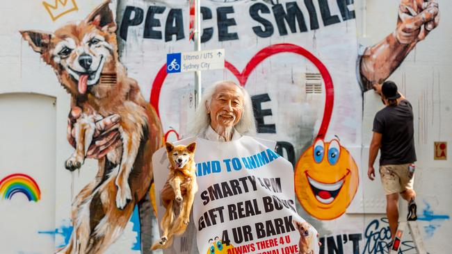 Danny Lim pictured with his dog Smarty in front of the mural of himself in Chippendale. Picture: Monique Harmer