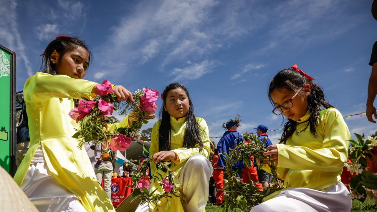 Girls prepare crowns from natural materials as they await the Royal couple. Photo by Brook Mitchell / POOL / AFP