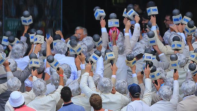 Bob Hawke skulls a beer in the Ritchie Benaud lookalike section during day 2 of the 5th Ashes test between Australia and England at the SCG. Picture: Mark Evans