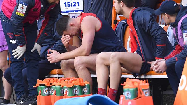 Steven May of the Demons sits on the bench after injuring his hamstring