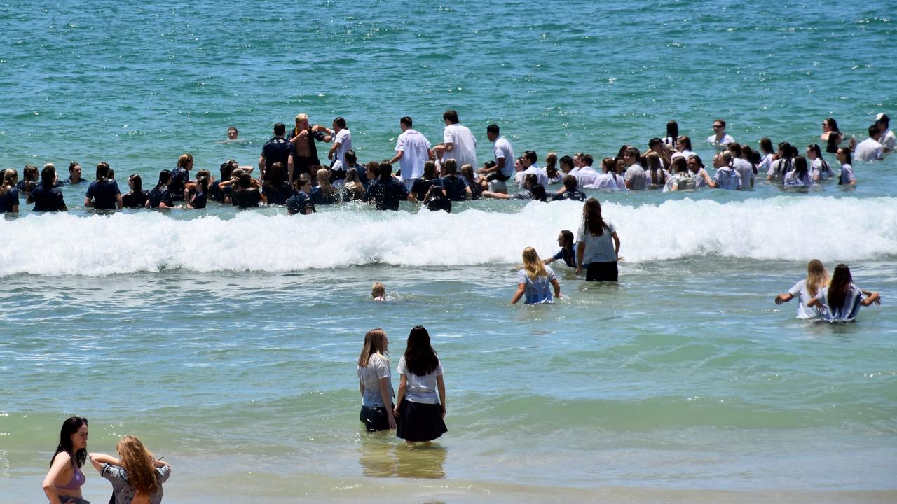 Year 12 graduates from schools across the Sunshine Coast hit to the water at Mooloolaba Beach to celebrate the end of their schooling. Photo: Mark Furler