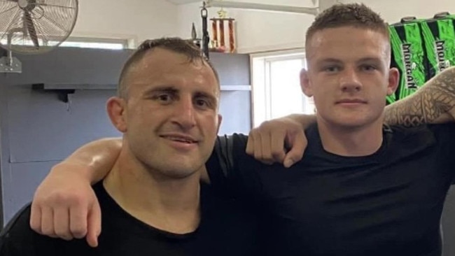 Jake Treyvaud (right) pictured with UFC champion Alexander Volkanovski (left), with whom he has trained with as a professional fighter.