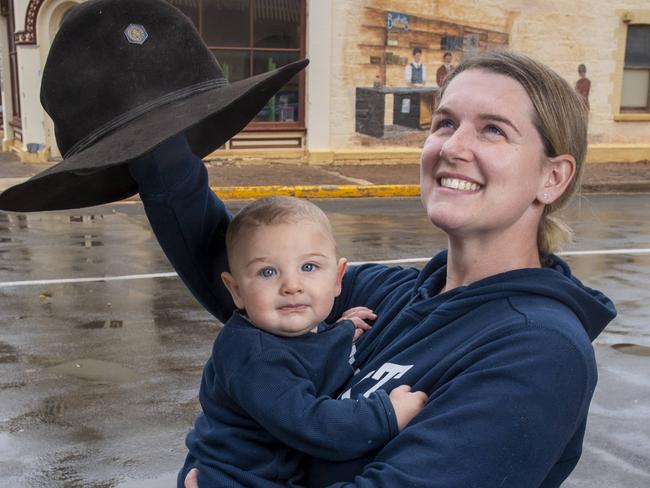 Peterborough primary school teacher Ayla Conway holds her baby boy Jasper 7 months as he sees rain for the first time  in the main street of Peterborough Monday,May,26,2025.Picture Mark Brake