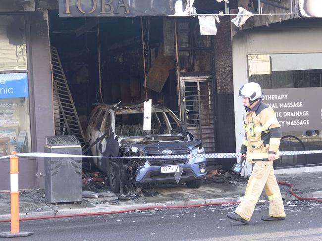 MELBOURNE,AUSTRALIA-NewsWire Photos 15 SEPTEMBER, 2024: Multiple Triple Zero calls were received for a vehicle into a shop on High St, Thornbury with FRV crews arriving on scene within 5 minutes, the vehicle wasreported as fully involved by fire inside the structure. Fire fighting crews donned breathing apparatus and commenced firefighting operations to containthe fire which was threatening to spread into shops on either side. At 04:20hrs the fire was given Under Control status and had been contained within the shop with no spread into adjoining businesses.. Picture: NewsWire / Valeriu Campan