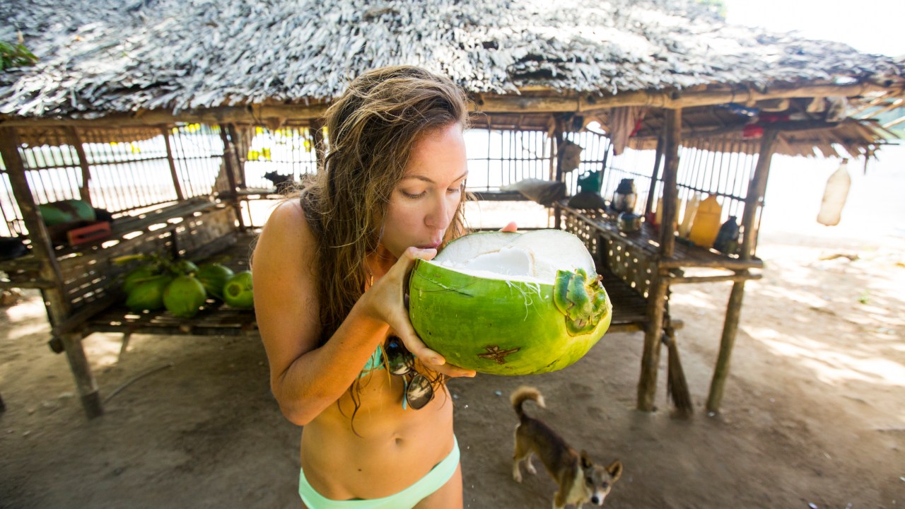 <p>Booze is also super cheap, with a local beer setting you back around $2 (that's not a beer that woman is drinking in that photo though, that's a coconut).&nbsp;</p>