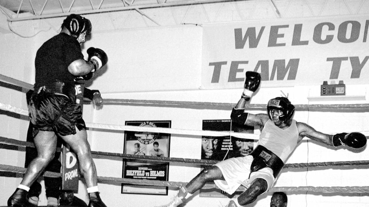 Mike Tyson knocks out sparring partner Leroy Seals during a workout.