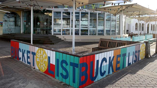 Bondi beach is open for the second day to swimmers and surfers as coronavirus restrictions begin to ease. The closed Bucket List bar/restaurant. Picture: Toby Zerna