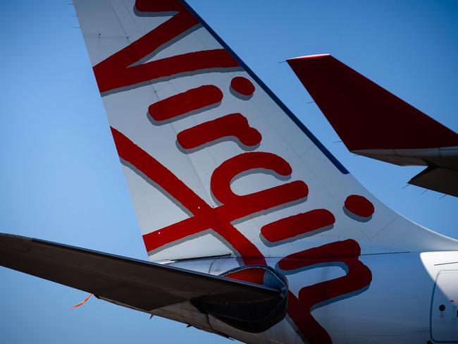 Virgin Australia aircraft are seen parked on the tarmac at Brisbane International airport on April 21, 2020. - Cash-strapped Virgin Australia collapsed on April 21, making it the largest carrier yet to buckle under the strain of the coronavirus pandemic, which has ravaged the global airline industry. (Photo by Patrick HAMILTON / AFP)