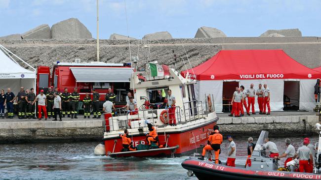 Divers arrive with a body bag in Porticello near Palermo. Picture: AFP.