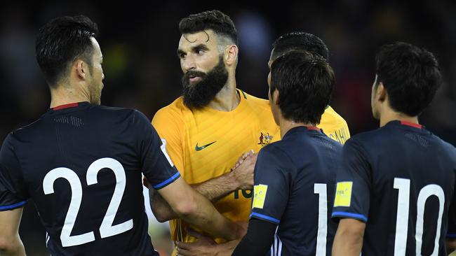 Mile Jedinak of Australia (second from left) and Japanese players are seen after the 2018 FIFA World Cup Qualifier game between Australia and Japan at Etihad Stadium.