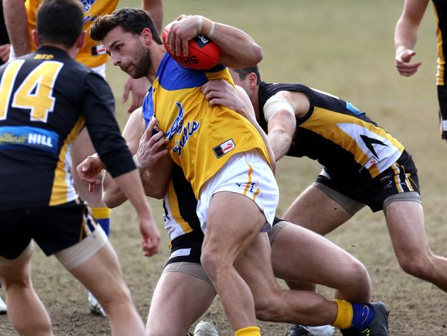 Ben Giobbi is brought down in a tackle for Noble Park. Picture: Stuart Milligan