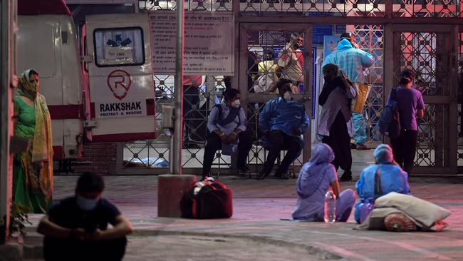 Relatives of coronavirus patients wait outside the emergency services of the JLNM hospital in New Delhi. Picture: AFP