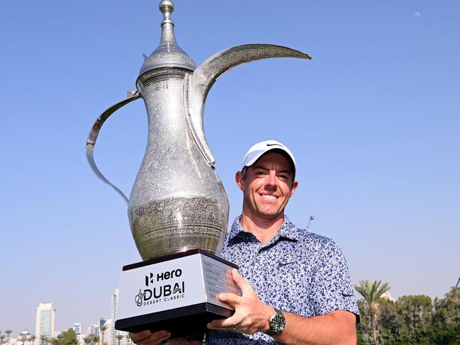 DUBAI, UNITED ARAB EMIRATES - JANUARY 30: Rory McIlroy of Northern Ireland celebrates with the winners trophy on the 18th green after the final round of the Hero Dubai Desert Classic at Emirates Golf Club on January 30, 2023 in Dubai, United Arab Emirates. (Photo by Ross Kinnaird/Getty Images)