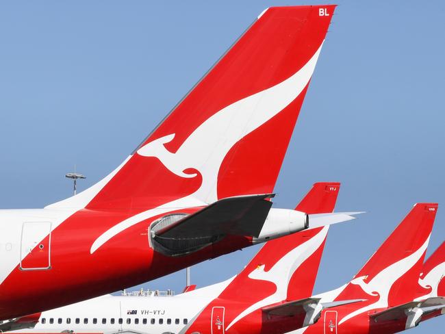 SYDNEY, AUSTRALIA - AUGUST 18: The tail fins of Qantas aircraft parked at Sydney's Kingsford Smith International Airport on August 18, 2021 in Sydney, Australia. Qantas Group has announced COVID-19 vaccinations will be mandatory for all 22,000 staff members. Frontline employees Ã¢â¬â including cabin crew, pilots and airport workers Ã¢â¬â will need to be fully vaccinated by November 15 and the remainder of employees by March 31. There will be exemptions for those who are unable to be vaccinated for documented medical reasons, which is expected to be very rare. (Photo by James D. Morgan/Getty Images)