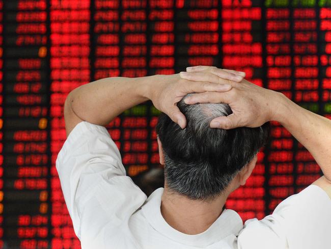 An investor gestures as he checks share prices at a securities firm in Shanghai on August 26, 2015. Shanghai stocks closed down 1.27 percent in volatile trading on August 26, extending days of falls despite a central bank interest rate cut aimed at boosting the flagging economy and slumping shares, dealers said. CHINA OUT AFP PHOTO