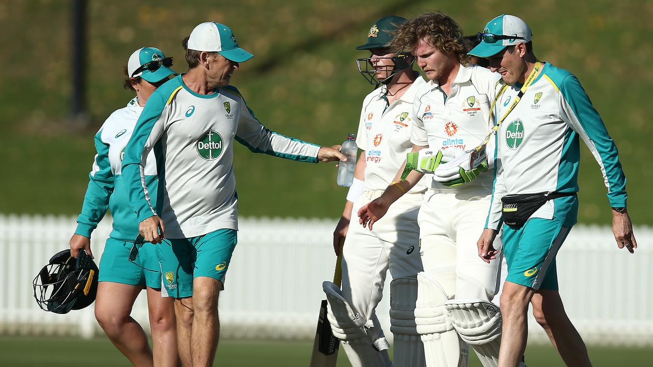 SYDNEY, AUSTRALIA - DECEMBER 08: Will Pucovski of Australia A is assisted from the field after been struck in the helmet off the bowling of Kartik Tyagi of India A during day three of the International Tour match between Australia A and India A at Drummoyne Oval on December 08, 2020 in Sydney, Australia. (Photo by Jason McCawley/Getty Images)