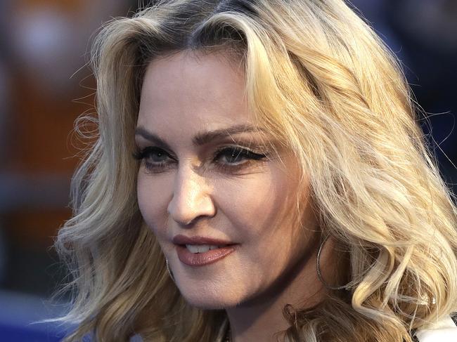 FILE- In this Sept. 15, 2016, file photo, musician Madonna poses for photographers upon arrival at the World premiere of the film "The Beatles, Eight Days a Week" in London. Pop star Madonna has filed for the adoption of two more children from Malawi. A government spokesman said the singer appeared before a High Court judge on Wednesday, Jan. 25, 2017. (AP Photo/Kirsty Wigglesworth, File)