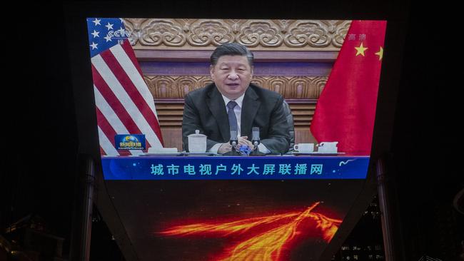 Xi Jinping is beamed down in Beijing during his virtual summit with Joe Biden on Tuesday. Picture: Getty Images