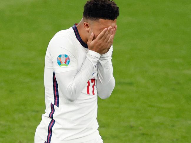 TOPSHOT - England's forward Jadon Sancho reacts after missing his penalty during the UEFA EURO 2020 final football match between Italy and England at the Wembley Stadium in London on July 11, 2021. (Photo by JOHN SIBLEY / POOL / AFP)