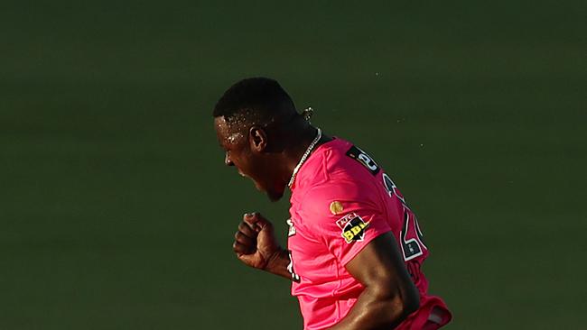 CANBERRA, AUSTRALIA - JANUARY 16: Carlos Brathwaite of the Sixers celebrates taking the wicket of Colin Munro of the Scorchers during the Big Bash League match between the Sydney Sixers and the Perth Scorchers at Manuka Oval, on January 16, 2021, in Canberra, Australia. (Photo by Mark Metcalfe/Getty Images)