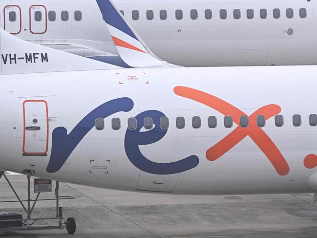 Rex Airlines Boeing 737 planes lay idle on the tarmac at Melbourne's Tullamarine Airport on July 31, 2024. The Australian regional airline Rex cancelled flights as it entered voluntary administration on July 31, leaving the fate of the country's third-largest carrier in serious doubt. (Photo by William WEST / AFP)