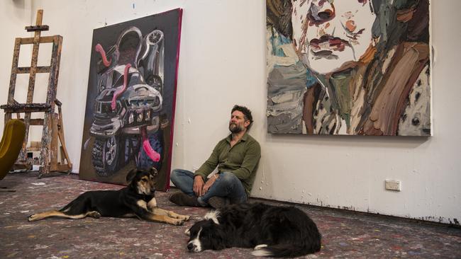 Quilty sits beneath his Archibald Prize-winning portrait of Margaret Olley. “When I showed her the painting she got very emotional, quite teary, and said, ‘There’s the old bitch.’ ” Picture: Andrew Quilty