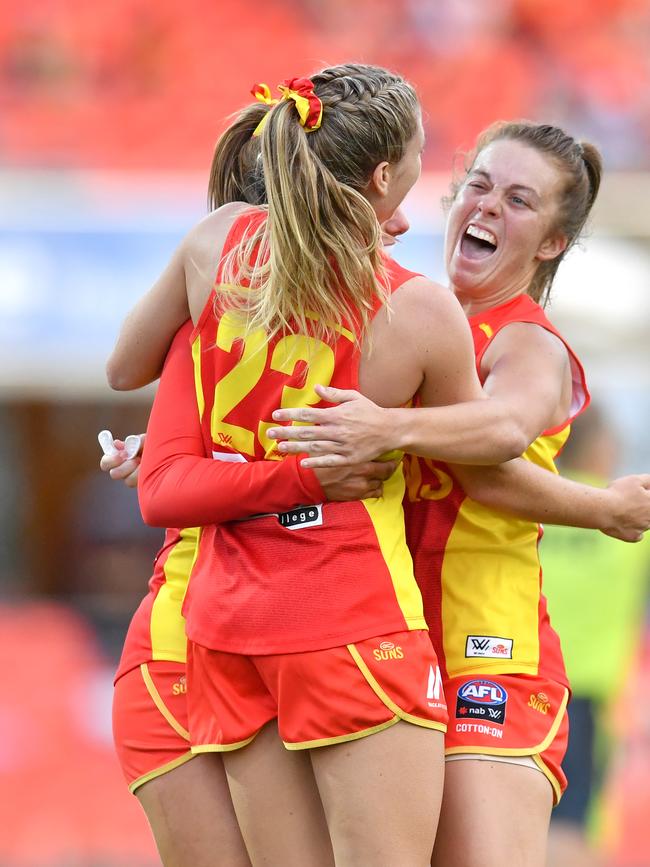 Kalinda Howarth of the Suns celebrates kicking a goal with Jamie Stanton (right) during the Round 3 AFLW match between the Gold Coast Suns and Brisbane Lions at Metricon Stadium on the Gold Coast, Saturday, February 22, 2020 (AAP Image/Darren England)