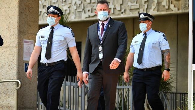 Constable Zachary Schembri (front) &amp; Constable Shane Warren leave the Townsville Courthouse after giving evidence at an inquest. Pictured with Queensland Police Union representative. Picture: Alix Sweeney