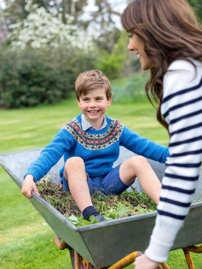 A smiling Prince Louis has been photographed being pushed in a wheelbarrow by his mother, the Princess of Wales for his fifth birthday.