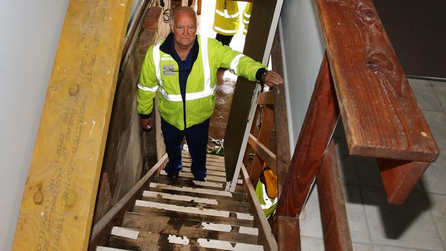 Marine Rescue Regional Controller Neil Grieves shows where the waves came up to at the top of stairs at its Terrigal headquarters during the king tide last night. Picture: Mark Scott