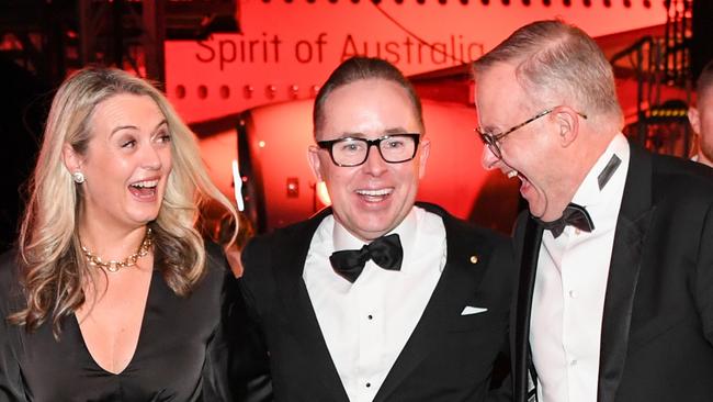 Alan Joyce, Anthony Albanese and his partner Jodie Haydon share a joke at the Qantas 100th Gala Dinner in 2023. Picture: James D. Morgan/Getty Images